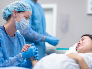 Nurse making comfortable to patient