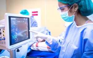 surgeon using monitor in operating room