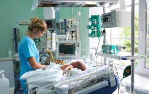 NICU nurse checking baby