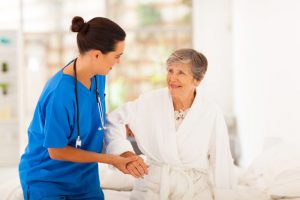Nurse helping an elderly patient walk