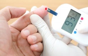 Nurse measuring blood sugar